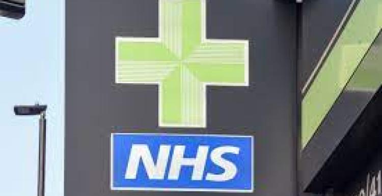 NHS white and blue logo underneath a green pharmacy cross 