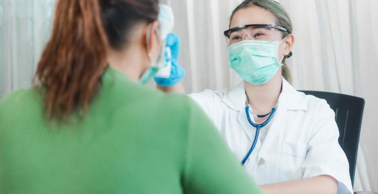 Female dentist examining a female patient's teeth