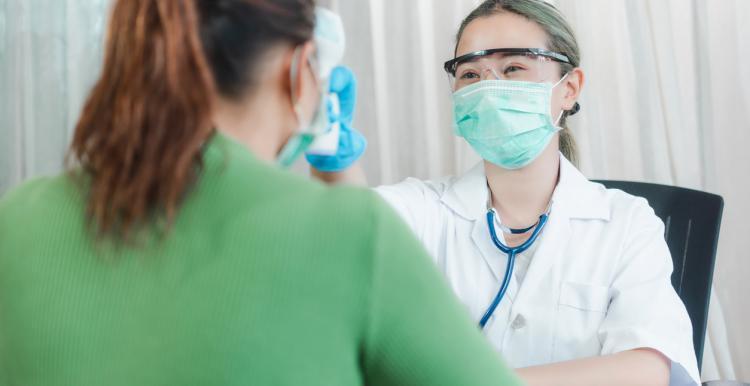 Female dentist examining a female patient's teeth