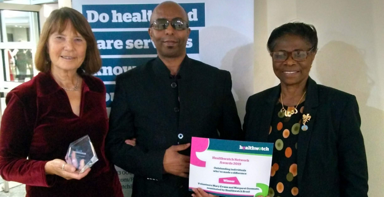 Two Healthwatch Brent volunteers and a member of staff receiving award certificate