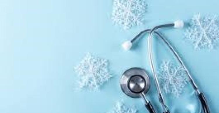There is a light blue background. In the right hand corner there is a stethoscope. Around the stethoscope is five snowflakes.