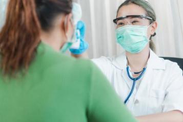 Female dentist examining a female patient's teeth